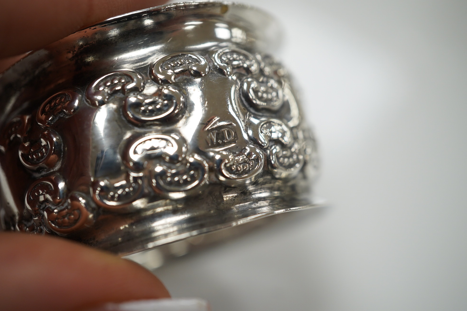 An Elizabeth II silver three piece condiment set, Sheffield, 1964, six assorted silver napkin rings and a stylish Austro Hungarian white metal pill box, by George Adam Scheid, 62mm. Condition - fair